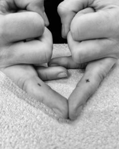 Handpoke mini symbols tattoos on the finger tips by Dot by Dot in Berlin